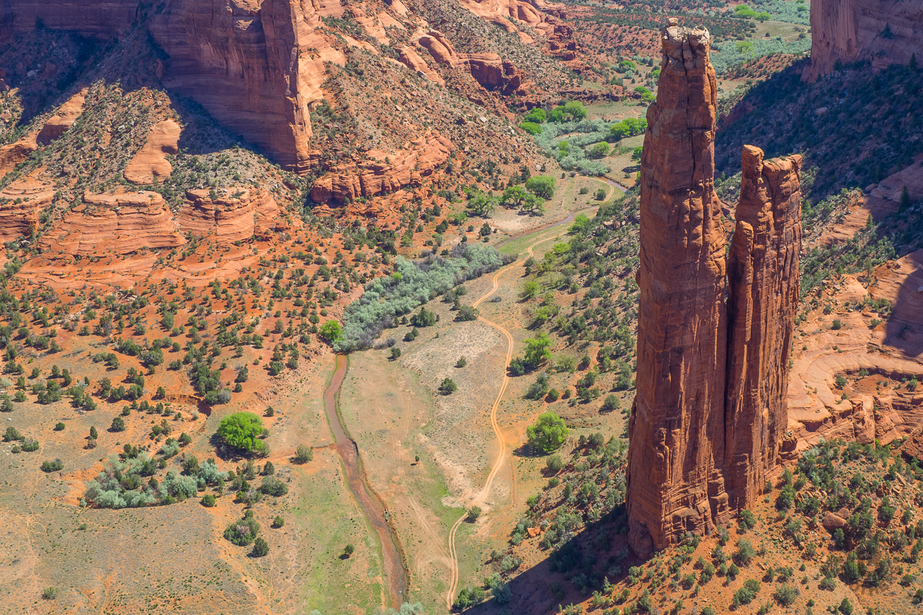 Spider Rock is an 800-foot sandstone spire that rises from the canyon floor at the junction of Canyon de Chelly and Monument Canyon. From the overlook you can see the volcanic core of Black Rock Butte and the Chuska Mountains on the horizon. Traditional stories of the Diné elders tell of the "Spider Woman" who wove her web of the universe and taught Diné to create beauty in their own life and spread the "Beauty Way" teaching of balance within the mind, body, and soul.