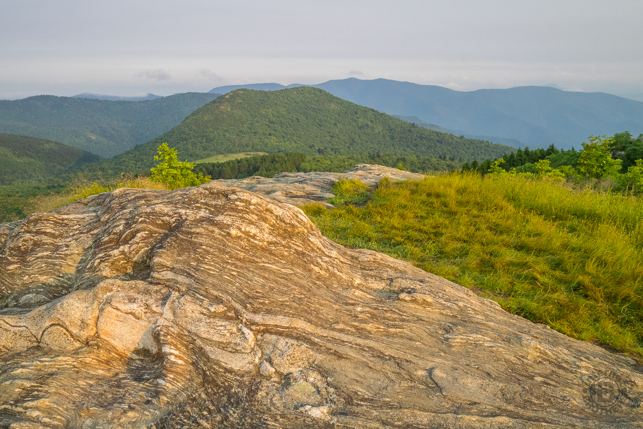 The plateaus along the Art Loeb Trail are covered with this exposed wavy granite. That is the double-humped Sam Knob in the background, the later destination for this hike.